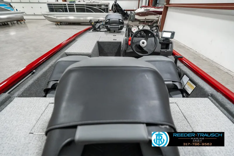 Slide: The Image of 2023 Tracker Pro 170 boat interior with steering wheel and seating in showroom. - 11