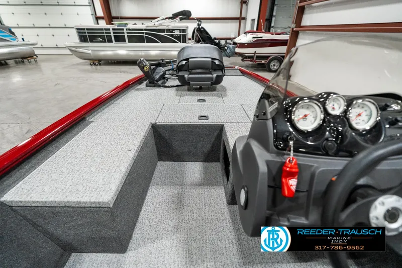 Slide: The Image of 2023 Tracker Pro 170 boat interior with dashboard and seating in showroom. - 12