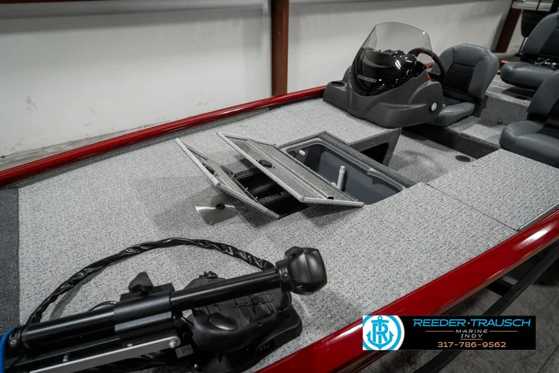 Slide: The Image of 2023 Tracker Pro 170 boat interior with open storage compartment and steering console. - 17
