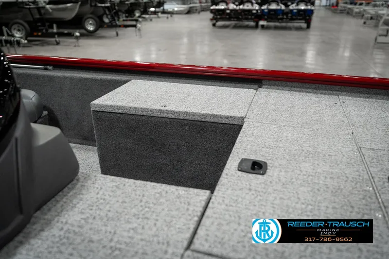 Slide: The Image of 2023 Tracker Pro 170 boat interior with gray carpet and storage compartment. - 18