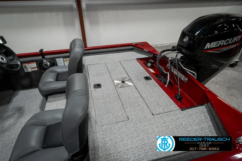 Slide: The Image of 2023 Tracker Pro 170 boat interior with Mercury engine, gray seats, and carpeted deck. - 23