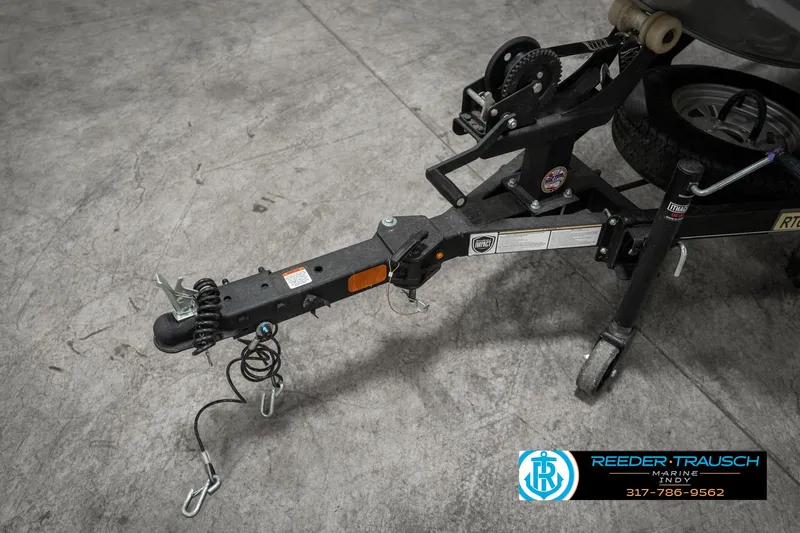 Slide: The Image of 2023 Tracker Pro 170 trailer hitch with safety chains on concrete floor. - 48