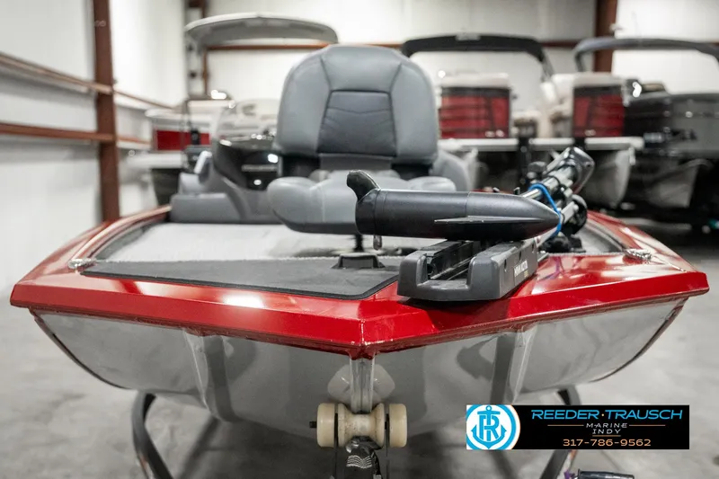 Slide: The Image of 2023 Tracker Pro 170 boat with red trim in showroom. - 6