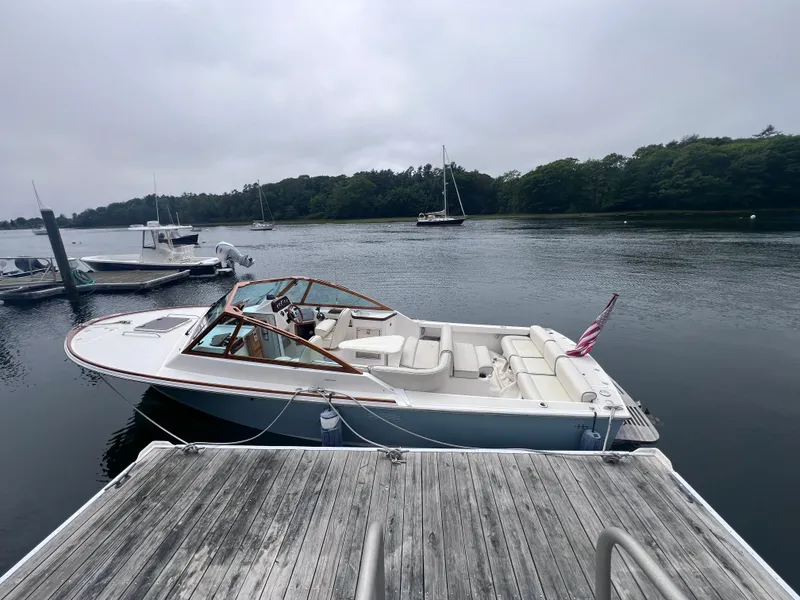 Slide: The Image of 2011 Hunt Yachts Harrier 25 docked on a serene lake. - 0