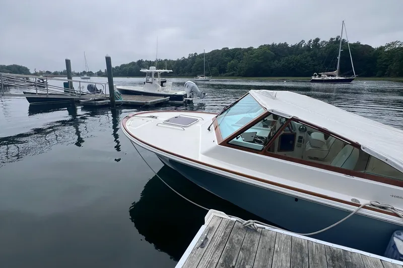 Slide: The Image of 2011 Hunt Yachts Harrier 25 docked in a serene marina setting. - 1