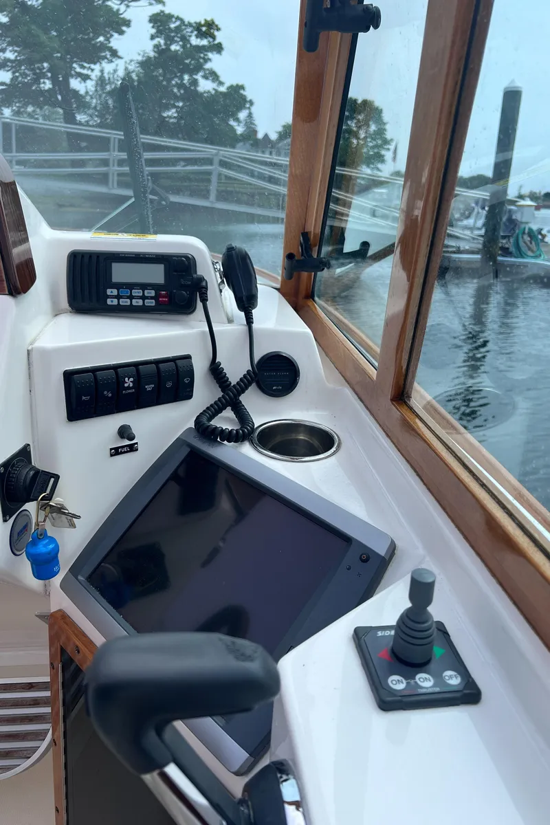 Slide: The Image of 2011 Hunt Yachts Harrier 25 cockpit with navigation controls and marine electronics. - 16
