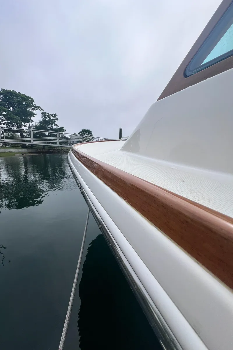 Slide: The Image of 2011 Hunt Yachts Harrier 25 boat docked on calm water. - 18