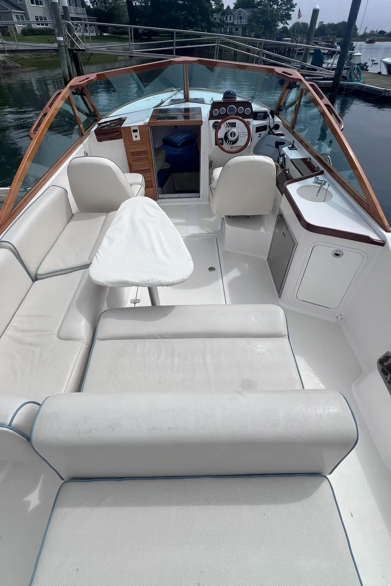 Slide: The Image of 2011 Hunt Yachts Harrier 25 interior with white seating and wooden accents. - 6