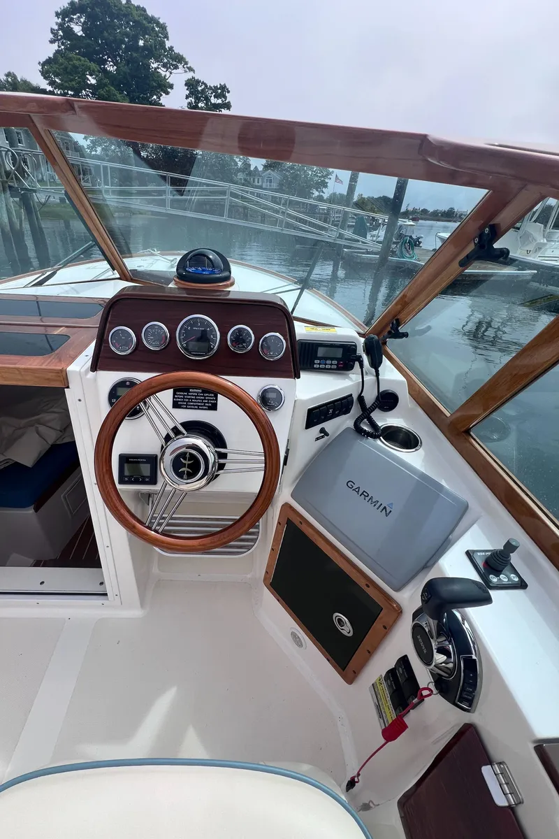Slide: The Image of 2011 Hunt Yachts Harrier 25 cockpit with wooden steering wheel and Garmin navigation system. - 7