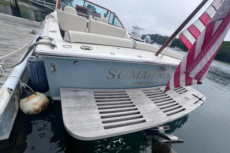 Slide: The Image of 2011 Hunt Yachts Harrier 25 docked with American flag, rear view. - 8