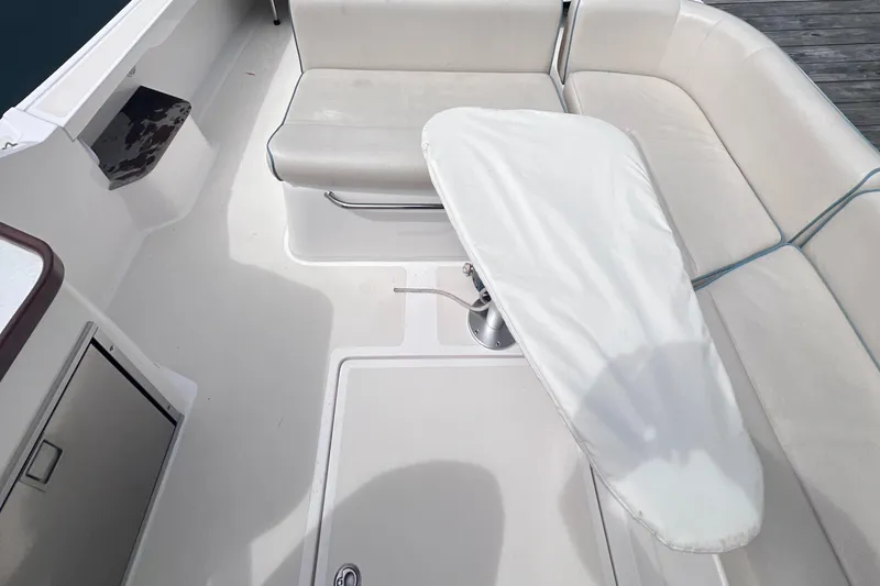 Slide: The Image of 2011 Hunt Yachts Harrier 25 interior with covered table and seating area. - 9