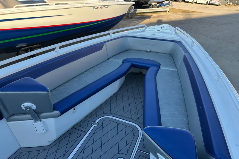Slide: The Image of Spacious seating area on a 2014 Concept 36 boat with blue and gray upholstery. - 10