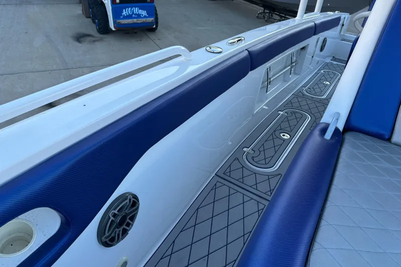 Slide: The Image of 2014 Concept 36 boat interior with blue and white seating and diamond-patterned flooring. - 12