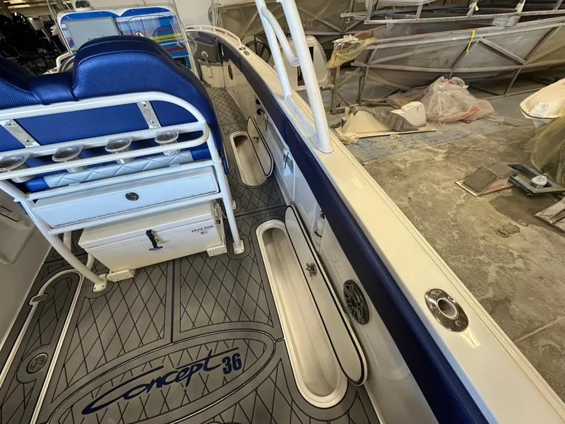 Slide: The Image of Interior of a 2014 Concept 36 boat with blue seating and custom flooring. - 18