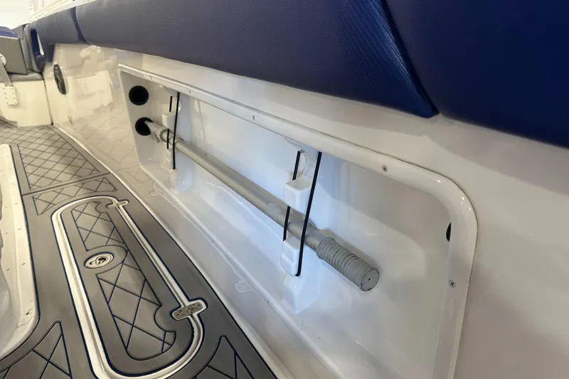 Slide: The Image of Interior view of a 2014 Concept 36 boat, featuring storage compartment and cushioned seating. - 25