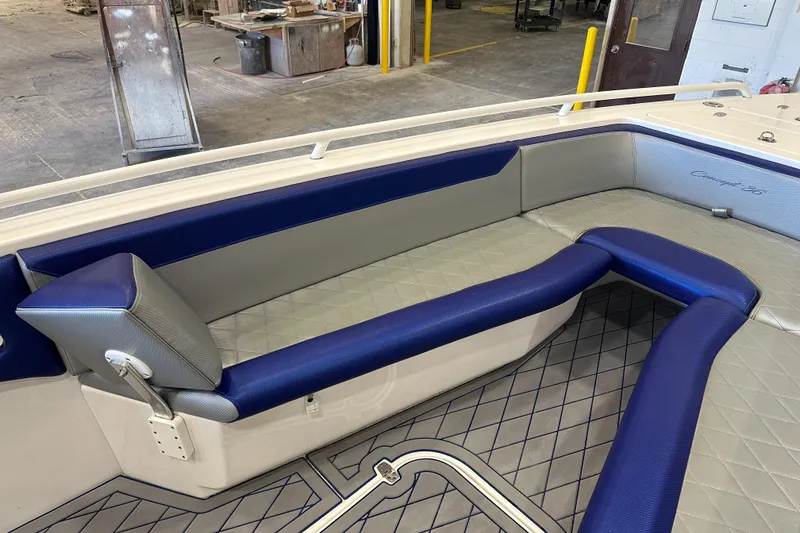 Slide: The Image of Luxurious seating area on 2014 Concept 36 boat, featuring blue and gray upholstery. - 27