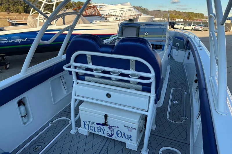 Slide: The Image of Concept 36 boat interior, 2014 model, featuring blue seating and "The Filthy Oar" cooler. - 6