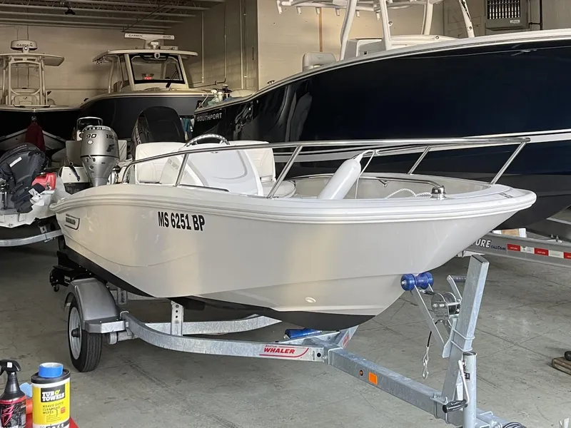 Slide: The Image of 2022 Boston Whaler 130 Super Sport boat on trailer in storage facility. - 3
