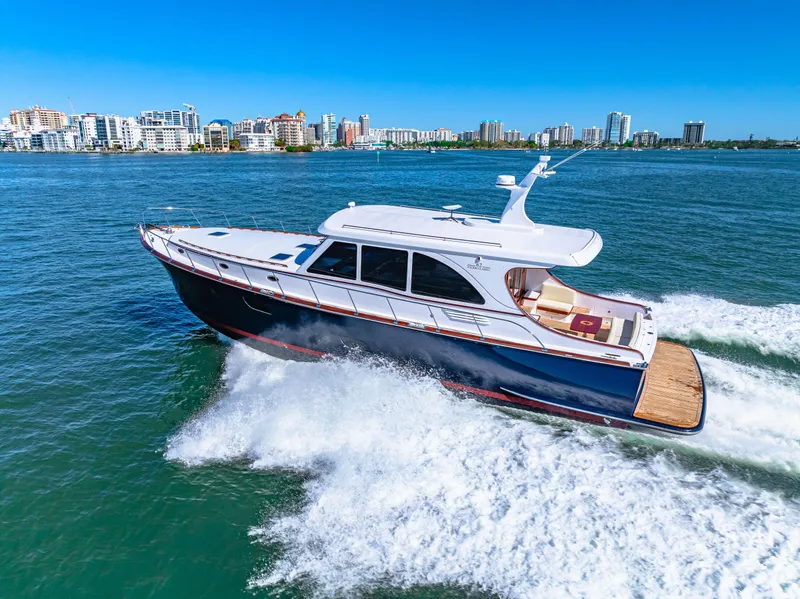Slide: The Image of 2024 Vicem 62 Classic yacht cruising on blue water near city skyline. - 35
