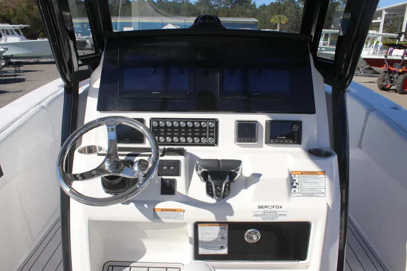 Slide: The Image of 2025 Sea Fox 288 Commander boat dashboard with steering wheel and controls. - 11