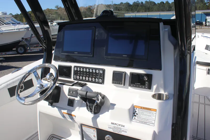 Slide: The Image of 2025 Sea Fox 288 Commander boat dashboard with dual screens and controls. - 27