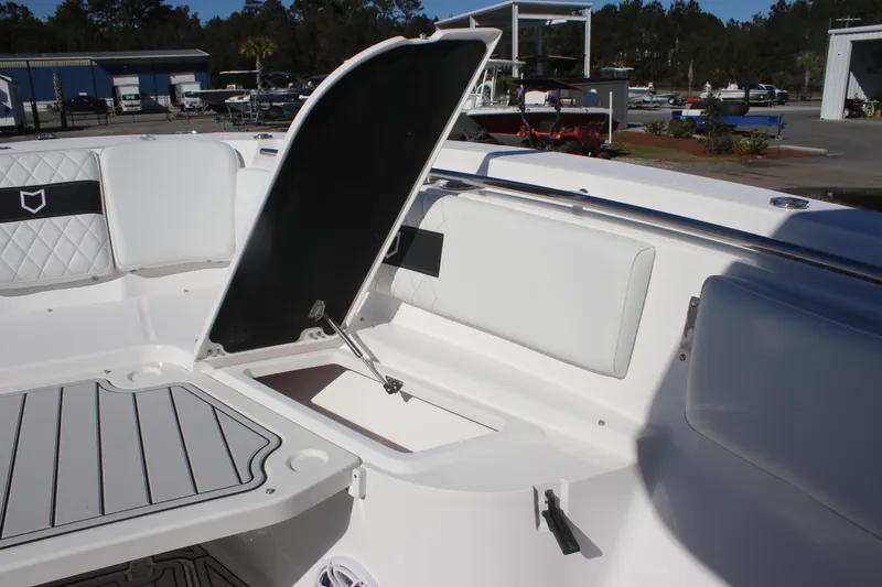 Slide: The Image of 2025 Sea Fox 288 Commander boat with open storage compartment and cushioned seating. - 9