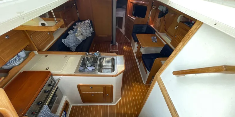 Slide: The Image of Interior of 2005 Catalina 350 MkII sailboat with kitchen and seating area. - 15