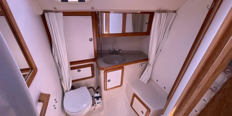 Slide: The Image of 2005 Catalina 350 MkII yacht bathroom with sink, toilet, and storage cabinets. - 21