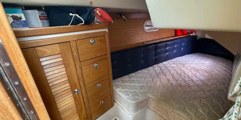 Slide: The Image of Cozy cabin interior of 2005 Catalina 350 MkII sailboat with wooden cabinetry and bed. - 24