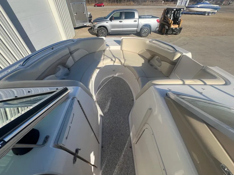 Slide: The Image of 2002 Chaparral Sunesta 243 boat interior with spacious seating and carpeted flooring. - 10