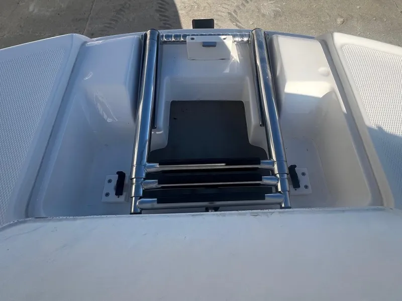 Slide: The Image of 2002 Chaparral Sunesta 243 boat ladder and storage compartment. - 11