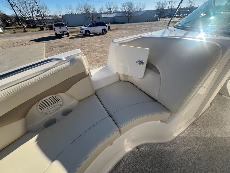 Slide: The Image of 2002 Chaparral Sunesta 243 boat interior with beige seating and storage compartment. - 12