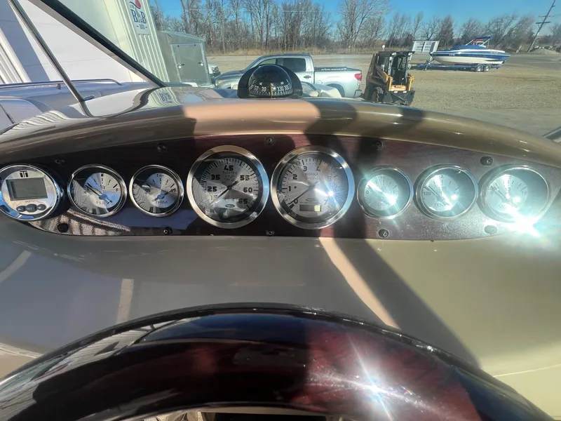 Slide: The Image of Dashboard of a 2002 Chaparral Sunesta 243 boat with gauges and steering wheel. - 19