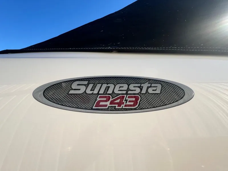 Slide: The Image of 2002 Chaparral Sunesta 243 logo on boat with blue sky background. - 2