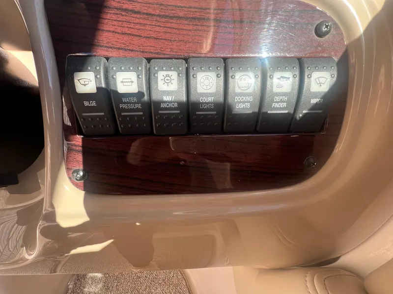 Slide: The Image of Control panel of a 2002 Chaparral Sunesta 243 boat with labeled switches. - 21