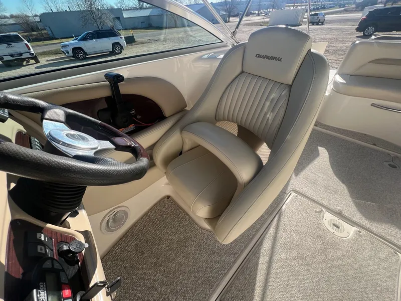 Slide: The Image of 2002 Chaparral Sunesta 243 boat interior with steering wheel and captain's chair. - 23