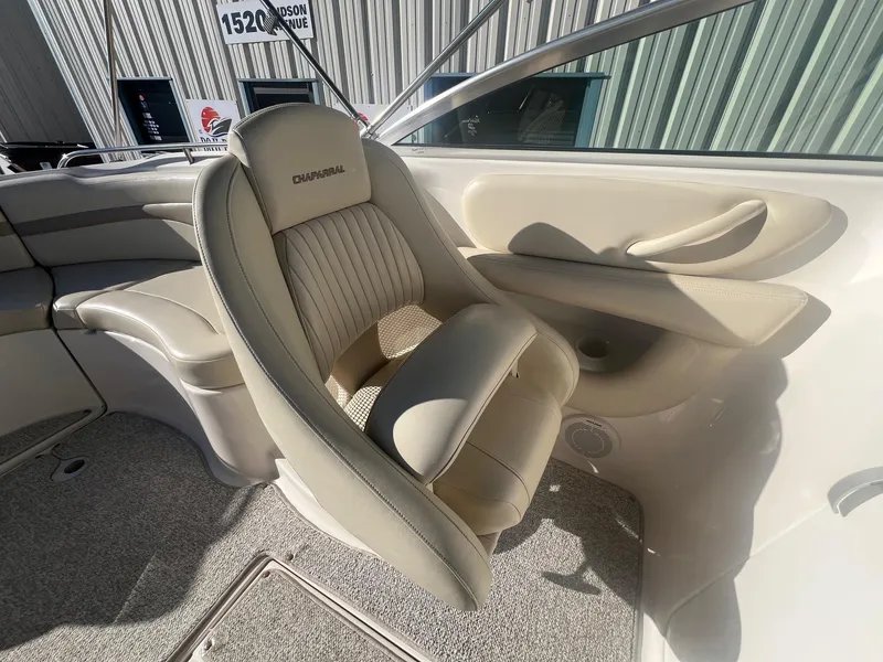 Slide: The Image of 2002 Chaparral Sunesta 243 boat interior with beige seating and carpeted flooring. - 24