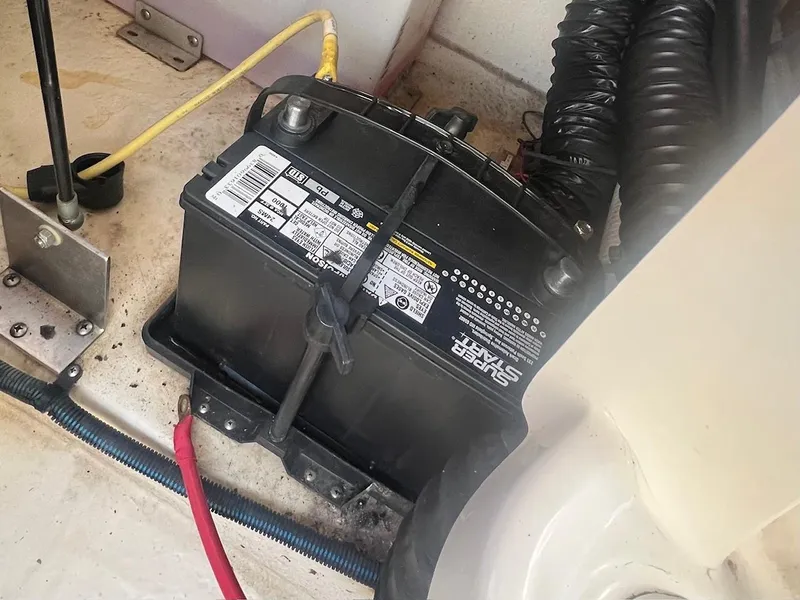 Slide: The Image of Battery compartment of 2002 Chaparral Sunesta 243 boat with wiring and connections. - 27