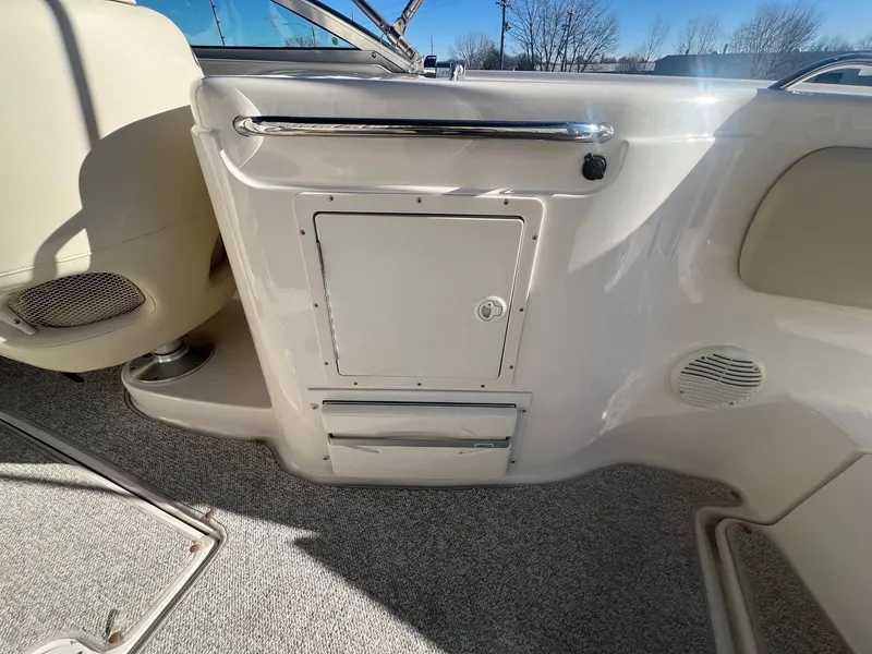 Slide: The Image of 2002 Chaparral Sunesta 243 boat interior with storage compartment and speaker. - 31