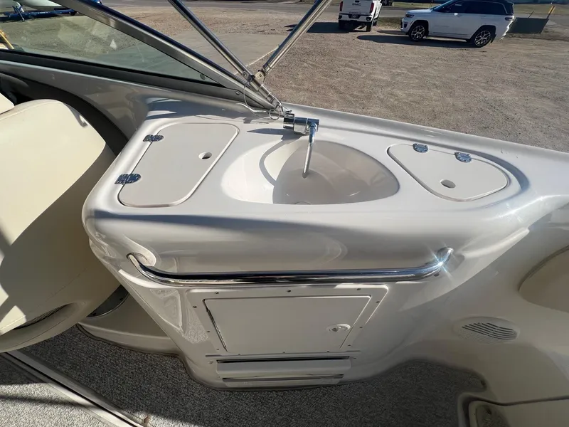 Slide: The Image of 2002 Chaparral Sunesta 243 boat interior with sink and storage compartments. - 32