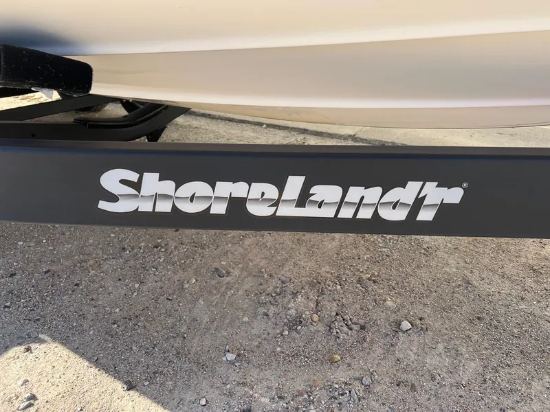 Slide: The Image of ShoreLand'r trailer for 2002 Chaparral Sunesta 243 boat on gravel surface. - 40
