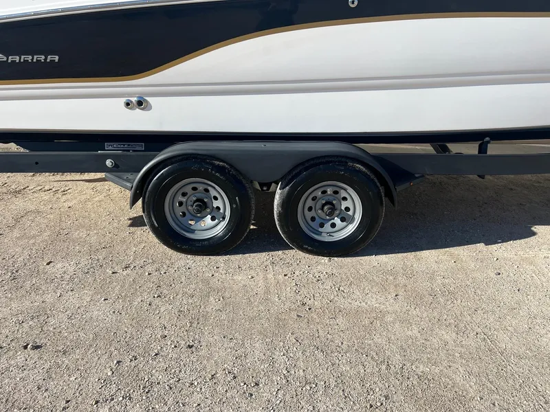 Slide: The Image of 2002 Chaparral Sunesta 243 boat on trailer, dual wheels, parked on gravel. - 41