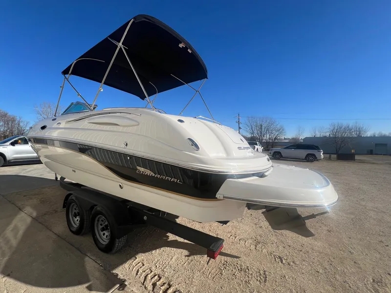Slide: The Image of 2002 Chaparral Sunesta 243 boat on trailer with canopy, parked outdoors. - 6