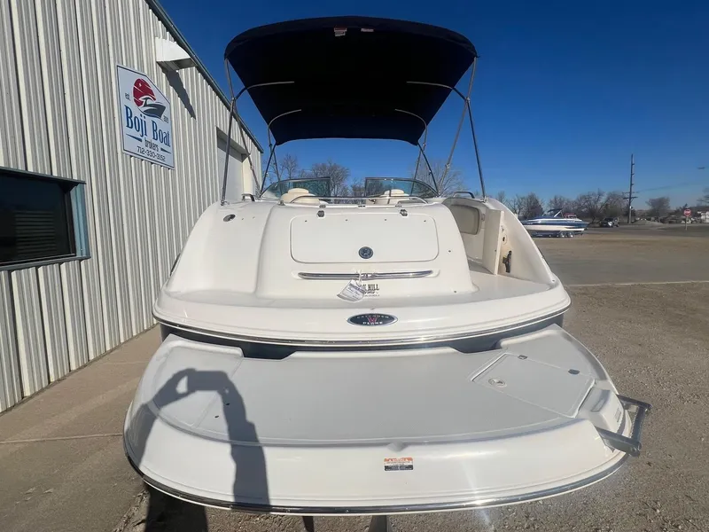 Slide: The Image of 2002 Chaparral Sunesta 243 boat with canopy, parked near Boji Boat building. - 7