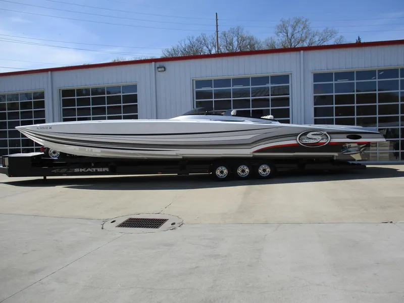 The Image of 2012 Skater 482 speedboat on trailer outside garage. - 1