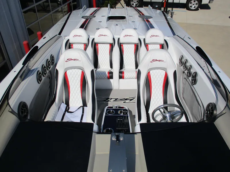 Slide: The Image of 2012 Skater 482 speedboat interior with white and red seats, sleek design, and multiple speakers. - 10