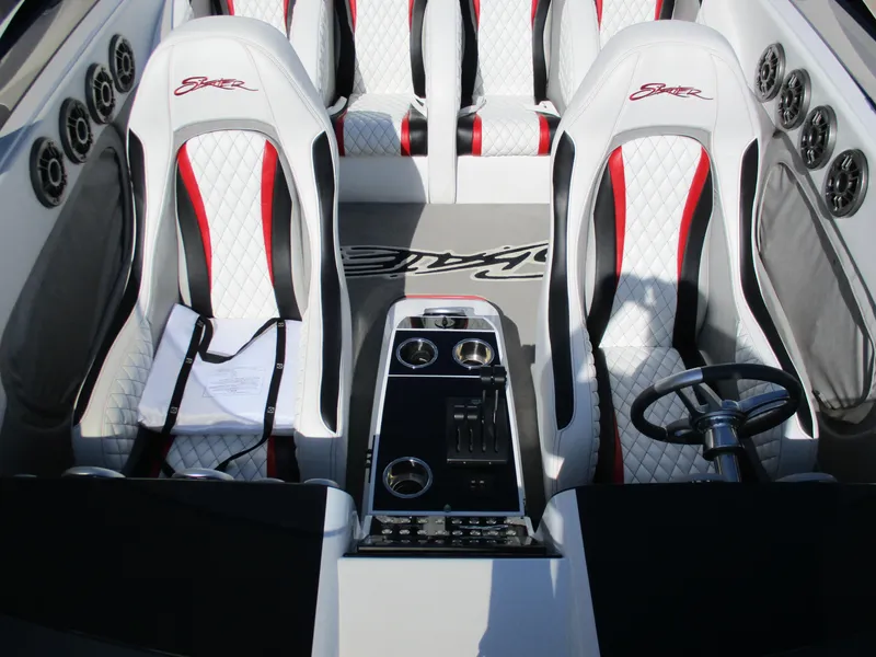Slide: The Image of Interior of 2012 Skater 482 boat with white and red seats, steering wheel, and control panel. - 11