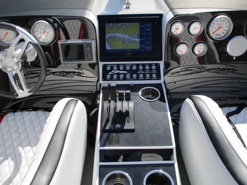 Slide: The Image of Dashboard of a 2012 Skater 482 boat with navigation and control panels. - 13