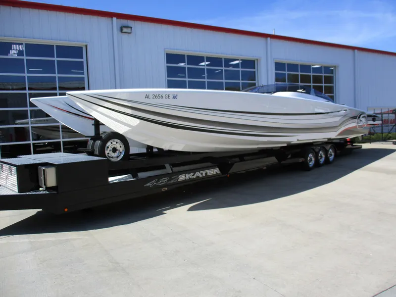 Slide: The Image of 2012 Skater 482 speedboat on trailer outside a garage. - 3