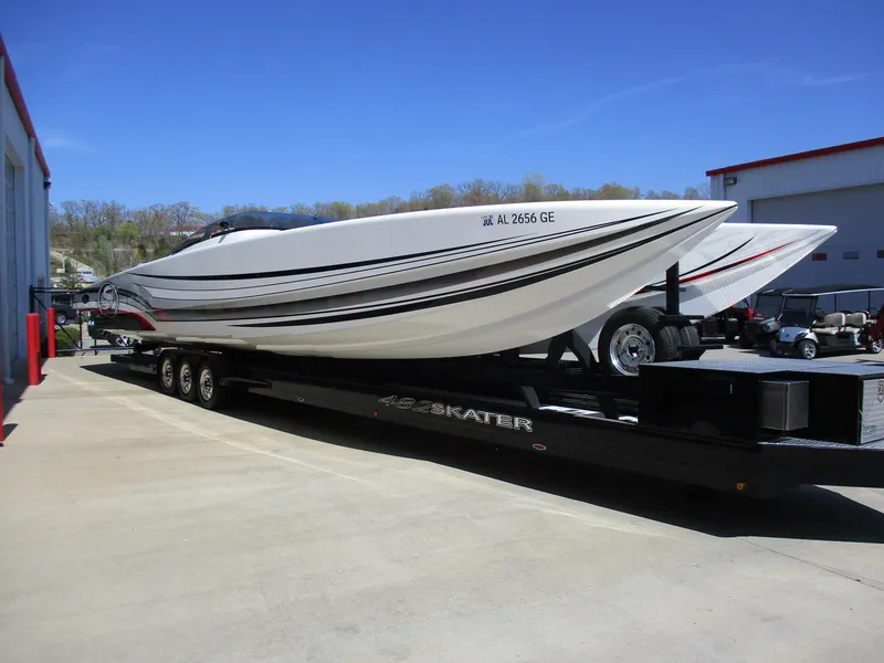 Slide: The Image of 2012 Skater 482 speedboat on trailer, parked outdoors under clear blue sky. - 5